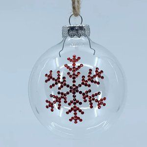 Round plastic Christmas ornament. Handmade red rhinestone snowflake design.